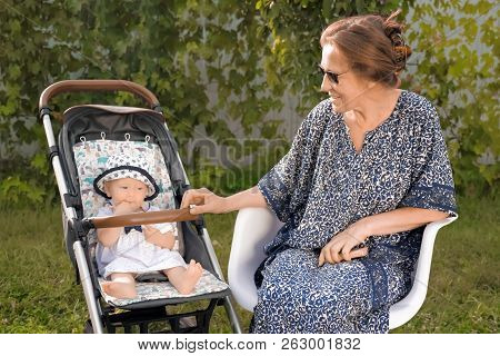 Grandmother And Granddaughter. Woman With Child. Family Having Fun Outdoor. Retirement Background. B