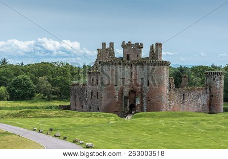 Shearington, Scotland, Uk - June 18, 2012: Ruined Triangular Brown Stone Moated Caerlavarock Castle 