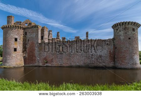 Shearington, Scotland, Uk - June 18, 2012: West Wall With Two Towers Of Ruined  Brown Stone Caerlava