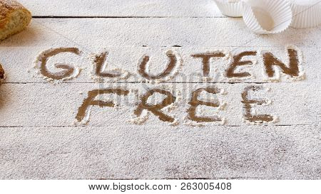 Gluten Free Concept. Wooden Table With Flour And Pastry Material, With The Written Phrase Gluten Fre