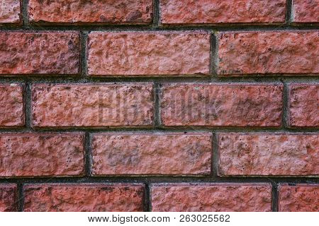 A Close Up Of A Red Bricked Wall. Bricky Texture. Brickwork Jointed Background. Seams Of A Brick Wal