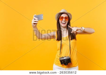 Tourist Woman In Summer Casual Clothes, Hat Doing Taking Selfie Shot On Mobile Phone Isolated On Yel