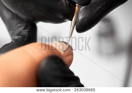 Close-up Of Professional Manicurist Hands In Black Rubber Gloves Painting Elegant Abstract Silver Gl