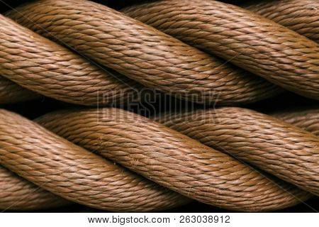 Thick Brown Rope Rolled Into A Roll. Horizontal Layout. Background Texture