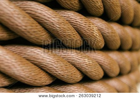 Thick Brown Rope Rolled Into A Roll. Horizontal Layout. Background Texture