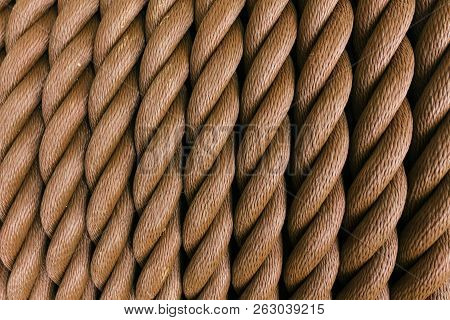Thick Brown Rope Rolled Into A Roll. Vertical Layout. Background Texture