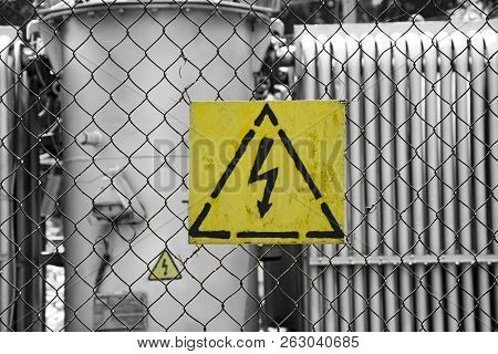 Warning Sign Of Electricity, High Voltage, Hanging On The Fence Around The Electrical Unit. Lightnin