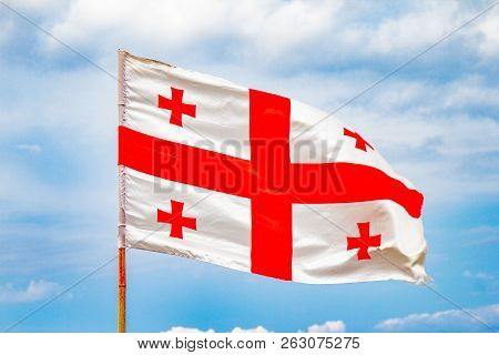 Beautiful View To Waving Flag Of Georgia On The Georgian Military Road Against The Background Of The