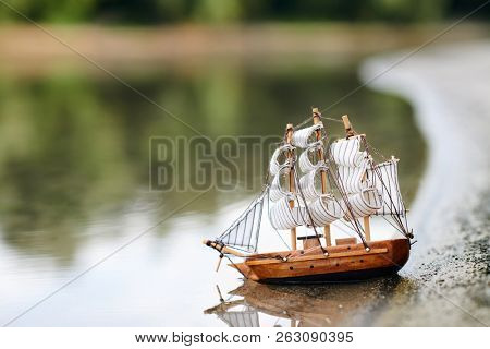 a toy sailing ship in the river