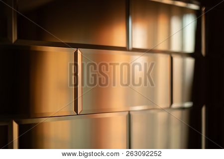 The Surface Of The Mirror Tiles. Wall Of Mirrored Tiles With Edges. Interior Design With Sunset Ligh