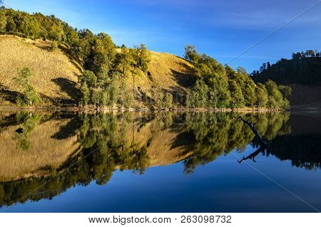 Beautiful Nature Landscape By The Lakeside Will Full Reflection In The Morning.ranu Kumbolo Lake, Se