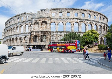 Pula, Croatia - June 18, 2014: Amphitheater Or Pula Arena. Local City People And Tourists Passing Th