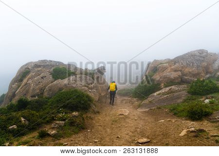 Backpackers On Foggy Trekking Path In Annapurna Conservation Area, Nepal