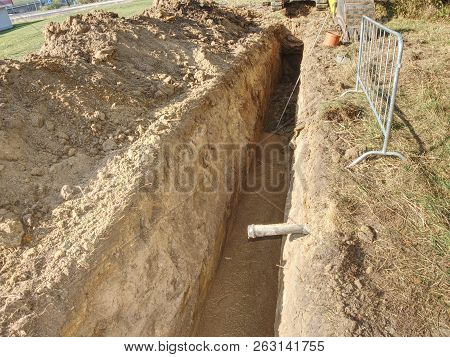 Repairing Of Plastic Tube Water Delivery System. Open Trench With Small Diameter Water Pipe And Heap