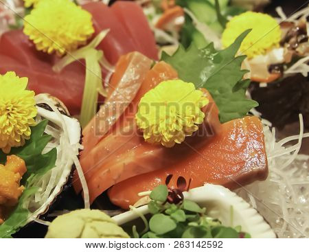 Salmon Sashimi Slices With Yellow Flower Garnish