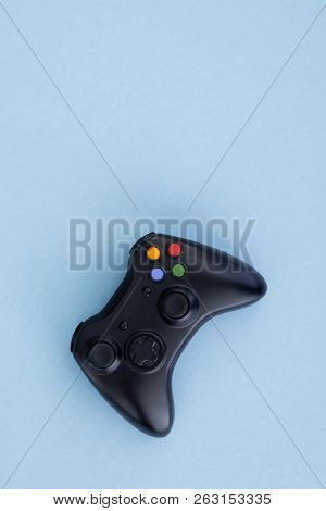 Black Joystick Is Isolated On A Pastel Blue Background. Video Game. Gaming Concept. Copyspace. Flayl