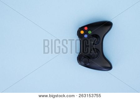 Black Joystick Is Isolated On A Pastel Blue Background. Video Game. Gaming Concept. Copyspace. Flayl