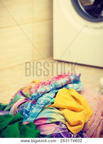 Big Pile Of Colorful Dirty Clothes For Laundry. Messy Fabric, Household Duties Objects Concept.