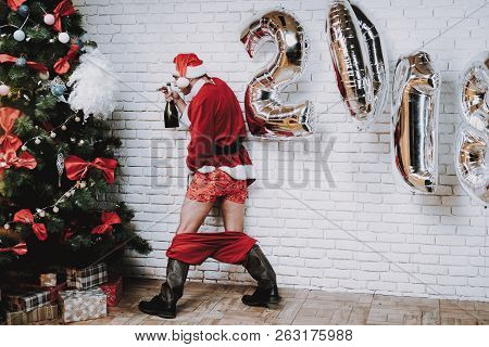 Drunk Santa Claus Near New Year Tree After Party. Christmas Tree In Office. Celebrating Of New Year.