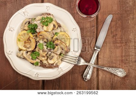 A Photo Of Scallopine Di Vitello, Veal Scallopini, With A Mushroom Sauce, Lemons, And Parsley, Shot 