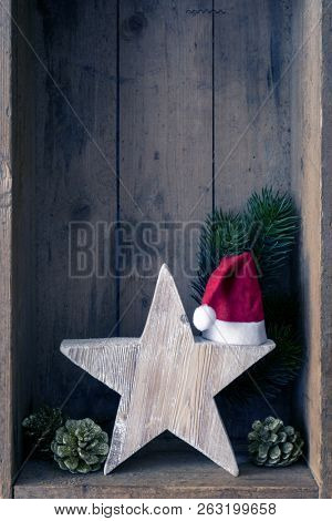 Christmas decoration Santa Clause hat on a star in a wooden box background