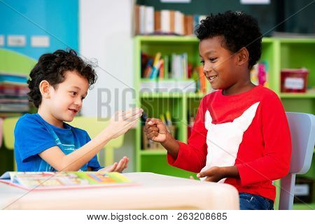 African Boy And American Boy Play Togather In Library, This Immage Can Use For Education, Kid And Pl