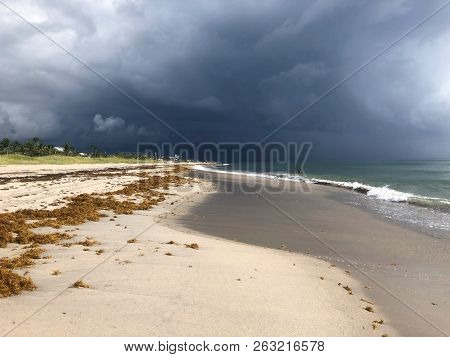 Storm Rolling Onto The Beach With Dark Clouds And Destruction