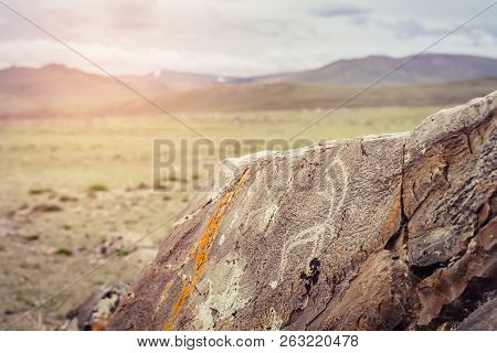 Tarkhatinsky Megalithic Complex Fragment. Ancient Petroglyphs. Altai Russia Toning Sunrise.
