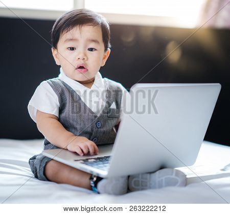 Asian Baby In Business Concept Use Computer Note Book, This Immage Can Use For Kid, Dream, Business,