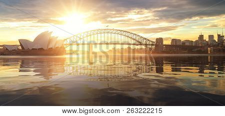 Cityscape Of Sysney Harbour And Bridge With Morning Sunrise Moment And Boat In The Sea, New South Wa