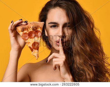 Young Beautiful Woman Hold Slice Of Pepperoni Pizza And Show Tss Quite Sing On Yellow Background