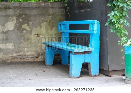 Old Blue Wooden Bench And Fallen Autumn Leaves