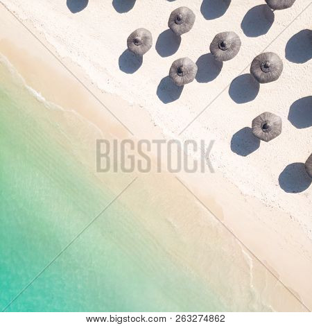 Aerial View Of Amazing Tropical White Sandy Beach With Palm Leaves Umbrellas And Turquoise Sea.