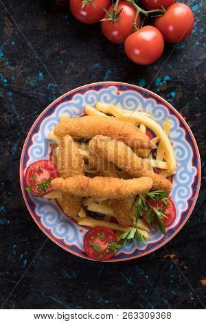Deep fried chicken frites with potato chips or french fries
