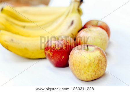 Ripe Bananas And Apples On Light Background