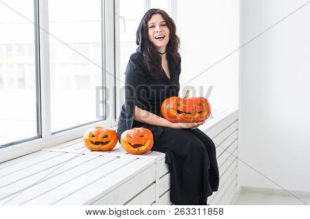 Halloween And Holidays Concept - Witch Woman With Jack Olantern Pumpkin