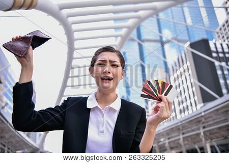 Concept Of Unemployed. Asian Businesswoman Is Opening Empty Wallet. Young Business Woman Is Stressed