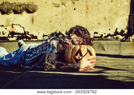 Bearded Zombie Man With Beard Creepy Vampire Or Bloody War Soldier With Wounds And Red Blood Lies On