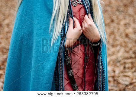 A Girl With Long Hair, Blonde, In A Blue Cape And A Pink Dress, Walks Through The Autumn Forest, Alo