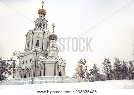 Christian Orthodox Church Winter Snowing Season Landscape With Snowy Covered Trees And Bright Sky