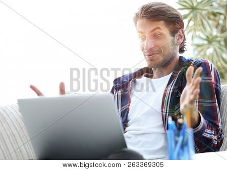 surprised guy working with laptop from home. concept of freelancing.