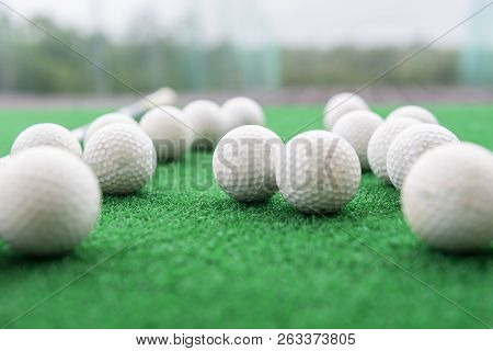 Golf Balls On A Synthetic Grass Mat At A Practice Range.
