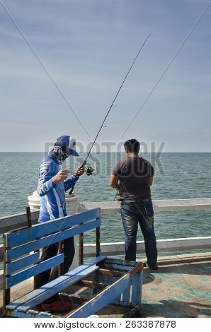 Thai Angler Or Fisherman Use Fishing-rod Fishing Fish In The Sea In Chonburi, Thailand