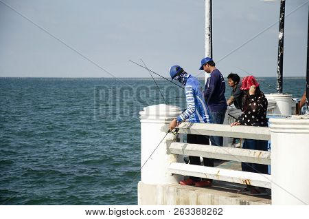Thai Angler Or Fisherman Use Fishing-rod Fishing Fish In The Sea In Chonburi, Thailand