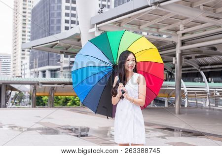 Asian Young Girl Smling And Holding Umbrella In City,lifestyle Concept,happy And Smiling