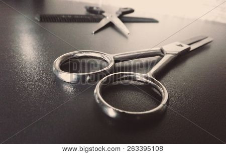 Shiny Scissors On Dark Background. Modern Hairdressing