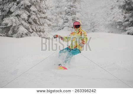 Girl Riding Down On The Snowboard On The Powdered Snow In The Mountain Popular Tourist Resort In God