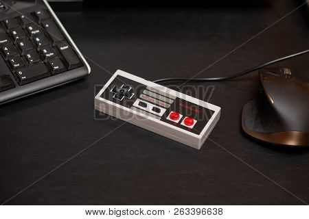 BUDAPEST, HUNGARY - FEBRUARY 17, 2018: Classic Nintendo NES console controller from the 80s on a desk