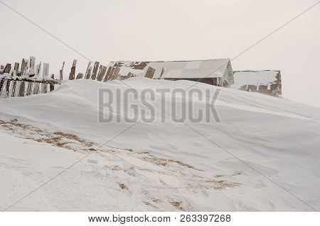 Winter Landscape Of Snow Covered Houses And Fence On The Mountain Hill On The Popular Tourist Resort