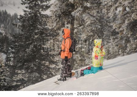Two Snowboarders Standing Back To Back On The Mountain Slope In The Popular Tourist Resort In Goderz